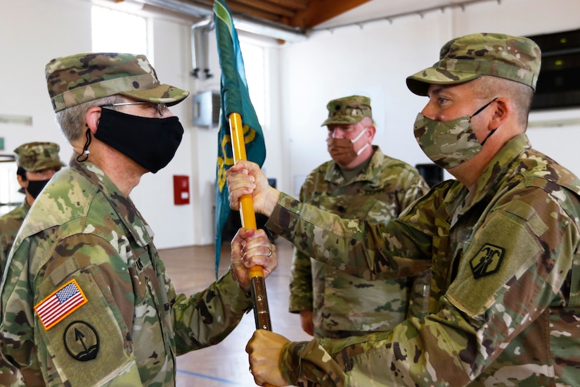 Col. Douglas LeVien, right, passes the unit colors to Lt. Col. Frank Suyak, incoming commander of the 209th Digital Liaison Detachment during a change of command ceremony July 19, 2020 in Wackernheim, Germany. The detachment, headquartered at U.S. Army Garrison Wiesbaden, is part of the U.S. Army Reserve’s 7th Mission Support Command and serves in direct support of U.S. Army Europe.  (U.S. Army Reserve photo by Staff Sgt. Chris Jackson/Released)