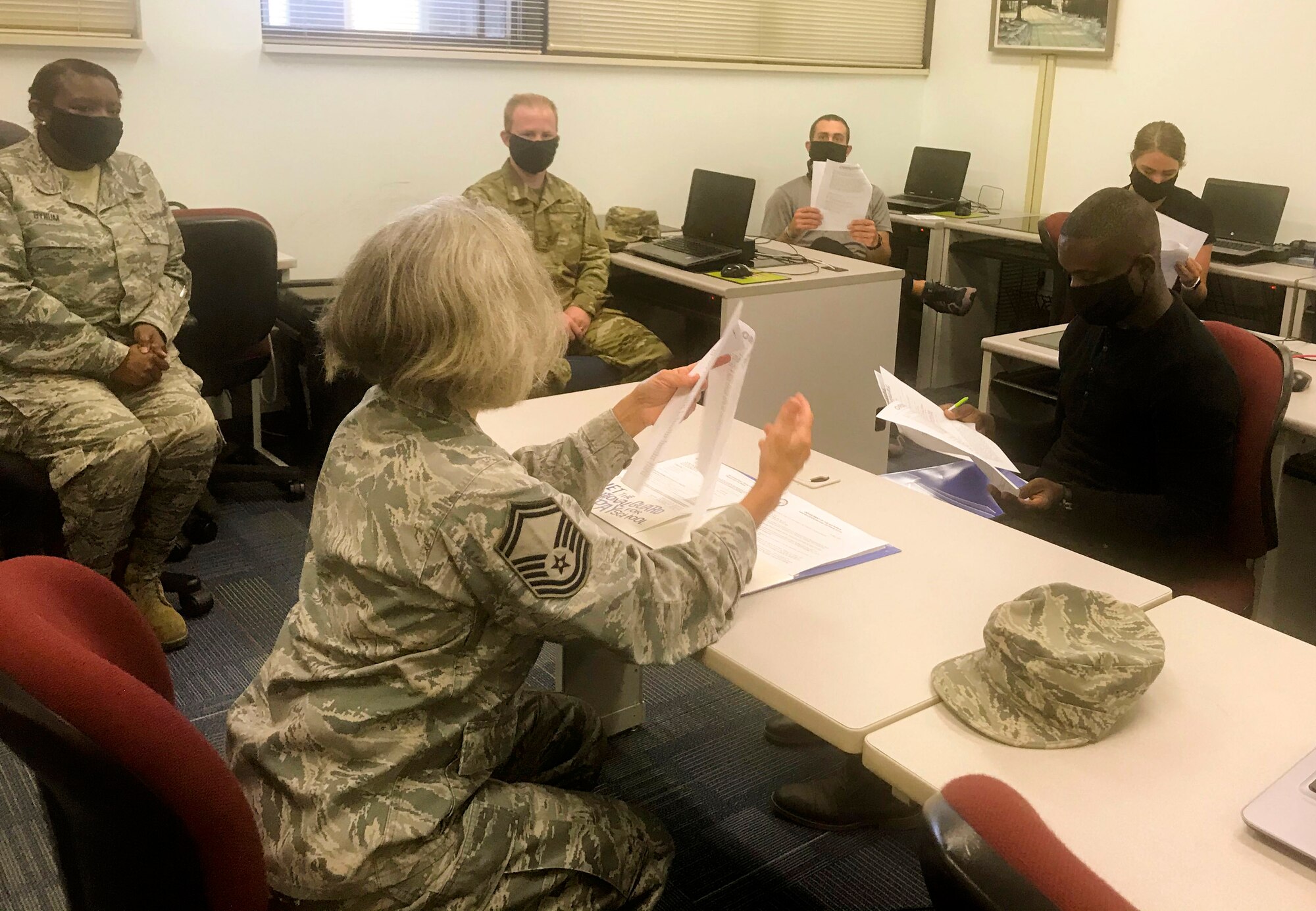 U.S. Air Force Senior Master Sgt. Sharon Fowler, 145th AW Force Development Superintendent (center), and U.S. Air Force Master Sgt. Angela Bynum, 145th AW Student Flight non-commissioned officer in charge (left) out-process recruits at the North Carolina Air National Guard base, Charlotte Douglas International Airport, that will be leaving for Basic Military Training. Per current base rules, to prevent the spread of Covid19, Student Flight has limited the number of recruits during drill to only those who leaving for Basic Military Training soon.