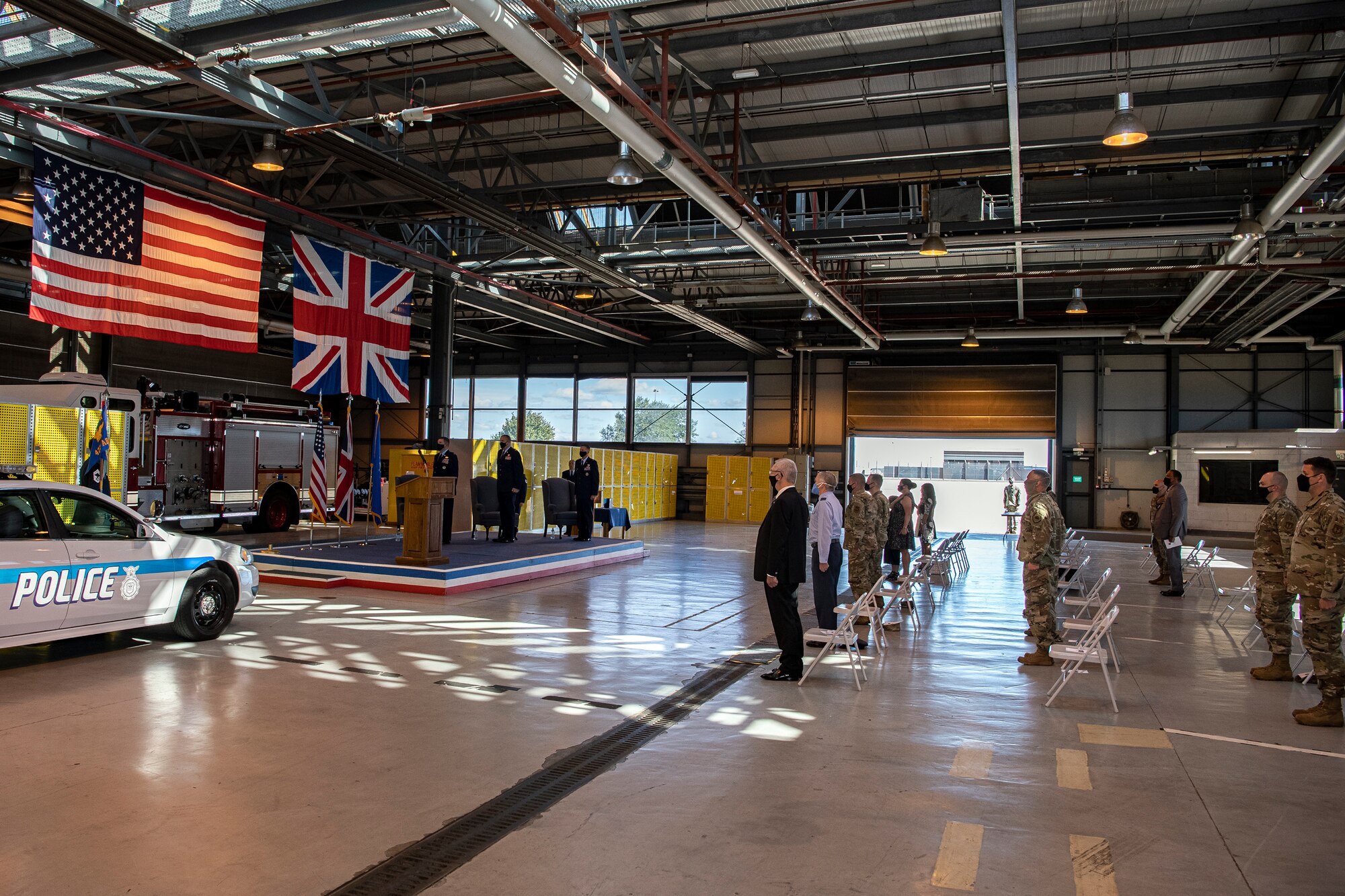 Airmen and guests from the 501st Combat Support Wing stand at attention, for the playing of the national anthem during the 423rd Air Base Group (ABG) change of command ceremony at RAF Alconbury, England, July 20, 2020. During the ceremony U.S. Air Force Col. Christopher Bromen relinquished command of the 423rd ABG to Col. Richard Martin. (U.S. Air Force photo by Senior Airman Eugene Oliver)