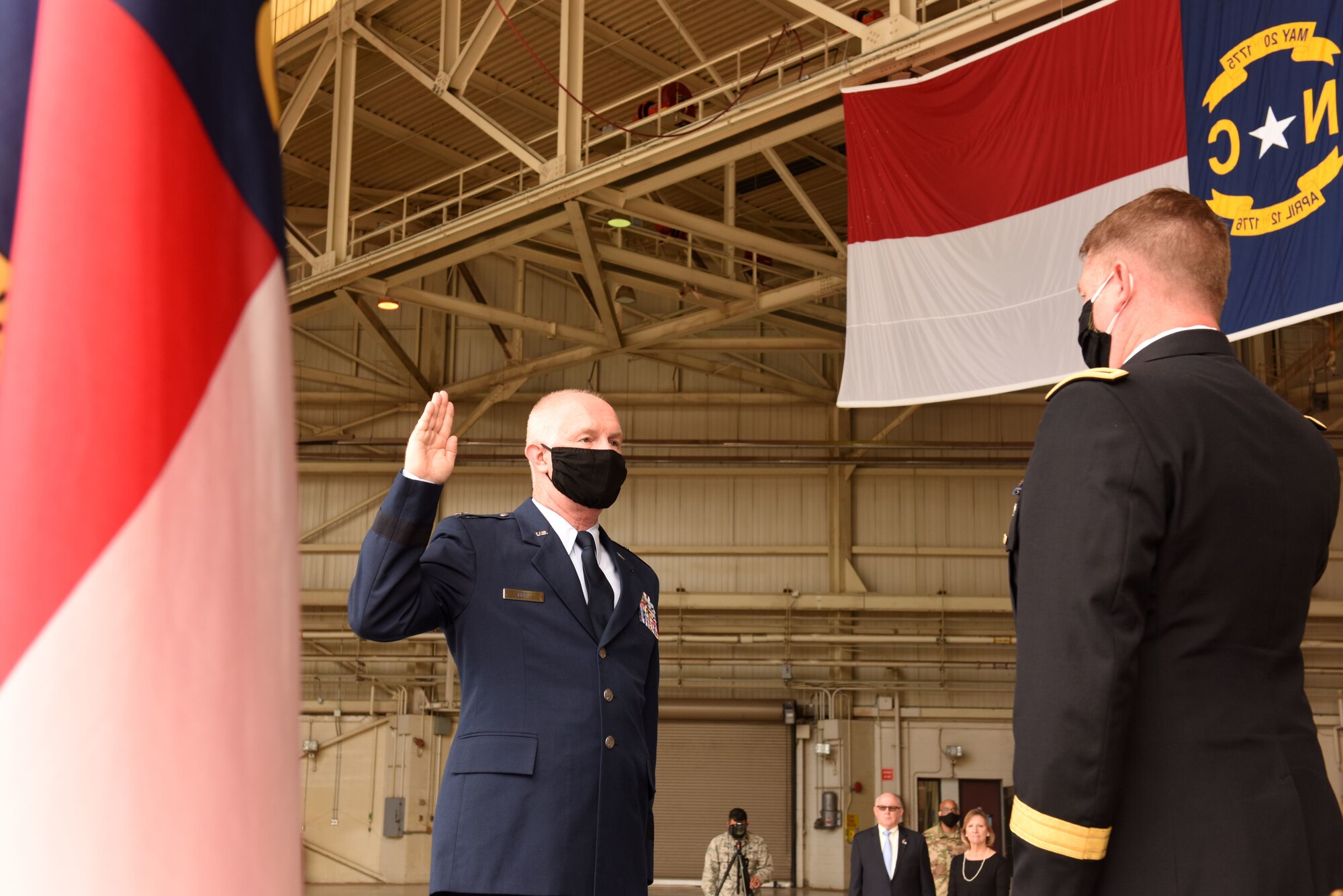 U.S. Army Maj. Gen. M. Todd Hunt (right), the Adjutant General of North Carolina National Guard (NCNG), leads U.S. Air Force Brig. Gen. Allan R. Cecil (left), NCNG Chief of Staff, in the reaffirmation of oath during Brig. Gen. Cecil’s promotion ceremony at the North Carolina Air National Guard Base, Charlotte Douglas International Airport, July 18, 2020. Family, friends, and guard members gather to watch Col. Cecil pin on the rank of Brigadier General.