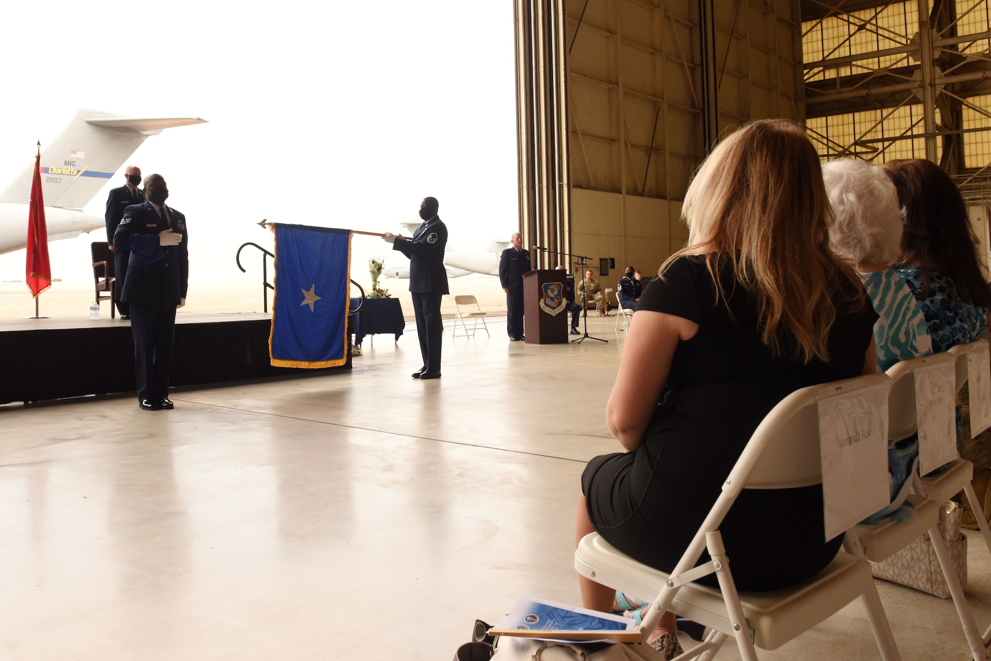 Members of the 145th Airlift Wing Honor Guard conduct the unfurling of personal colors for U.S. Air Force Brig. Gen. Allan R. Cecil, North Carolina National Guard (NCNG) Chief of Staff, during Brig. Gen. Cecil’s promotion ceremony at the North Carolina Air National Guard Base, Charlotte Douglas International Airport, July 18, 2020. Family, friends, and guard members gather to watch Col. Cecil pin on the rank of Brigadier General.