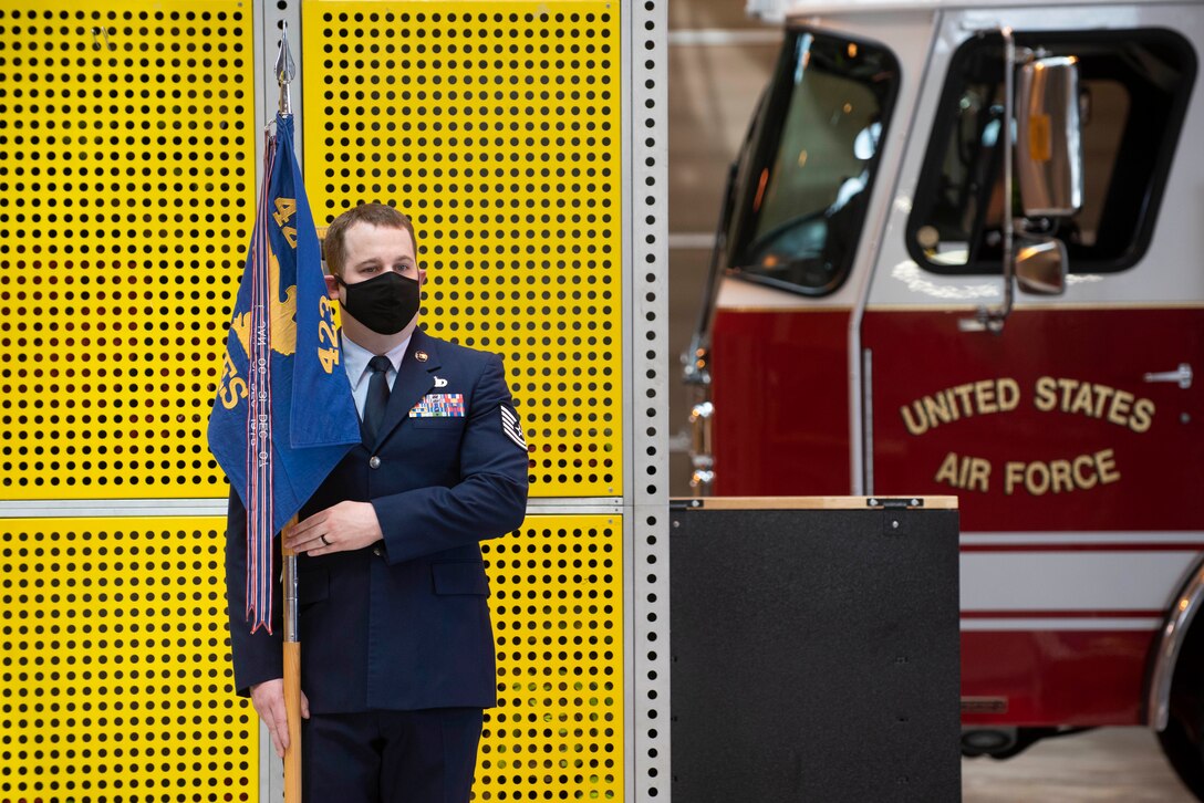 U.S. Air Force Tech. Sgt. Tyler Whaley, 423rd Civil Engineer Squadron Airmen dorm leader, holds the guidon during the 423rd CES Change of Command ceremony at RAF Alconbury, England, July 17, 2020. The change of command ceremony is rooted in military history dating back to the 18th century representing the relinquishing of power from one officer to another. (U.S. Air Force photo by Airman 1st Class Jennifer Zima)