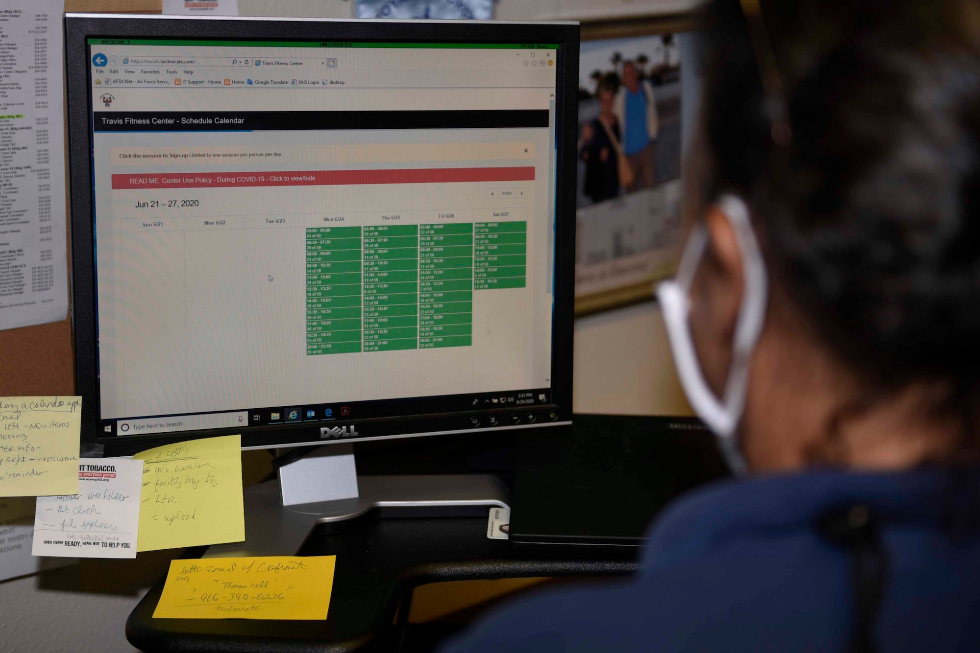 Tanya McCormick, 60th Force Support Squadron fitness and sport center manager, checks the Travis Fitness Center schedule calendar June 24, 2020, at Travis Air Force Base, California. McCormick helped develop the scheduling system to enable the fitness center to reopen amid the COVID-19 pandemic while complying with public health guidelines. (U.S. Air Force photo by Airman 1st Class Cameron Otte)