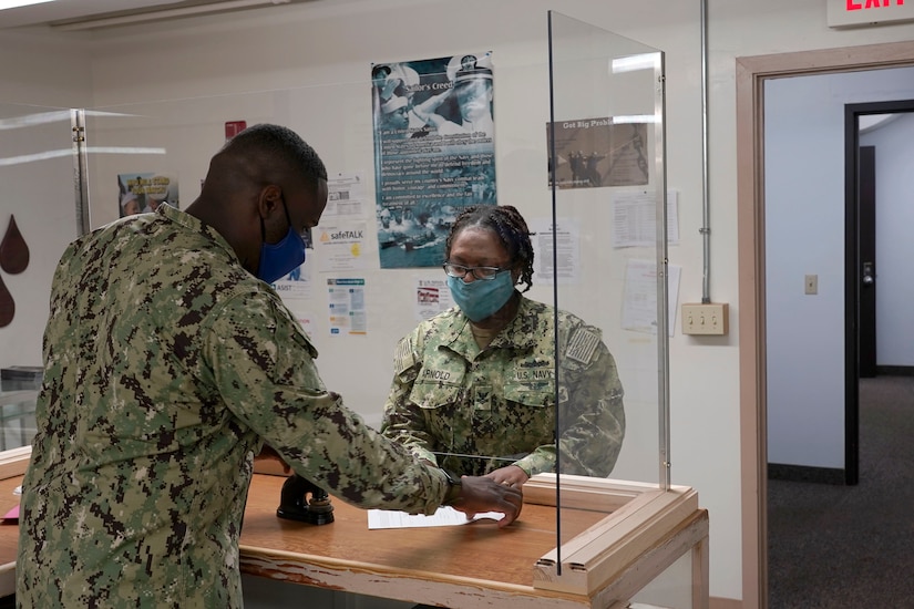 Navy sailors and contractors working.