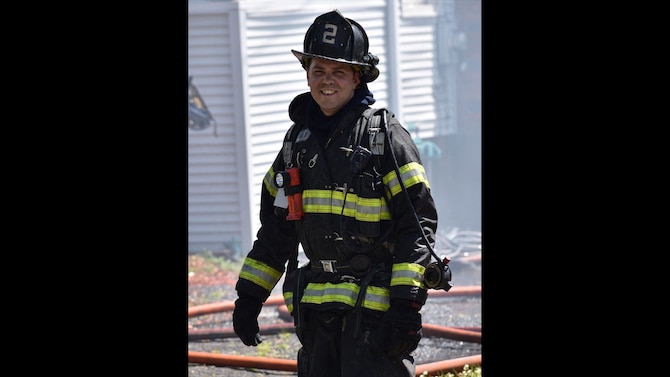 Tech. Sgt. Brian Nasuta, an aerial transportation specialist with the 58th Aerial Port Squadron, smiles for a photo while on a firefighting assignment on June 14, 2020, in Windsor, Connecticut. Nasuta has been a firefighter for 10 years. (Courtesy photo by South Green Fire Photos)