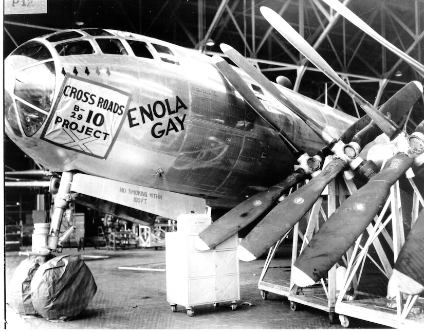 Several propellers are propped up against the nose of a plane under construction.