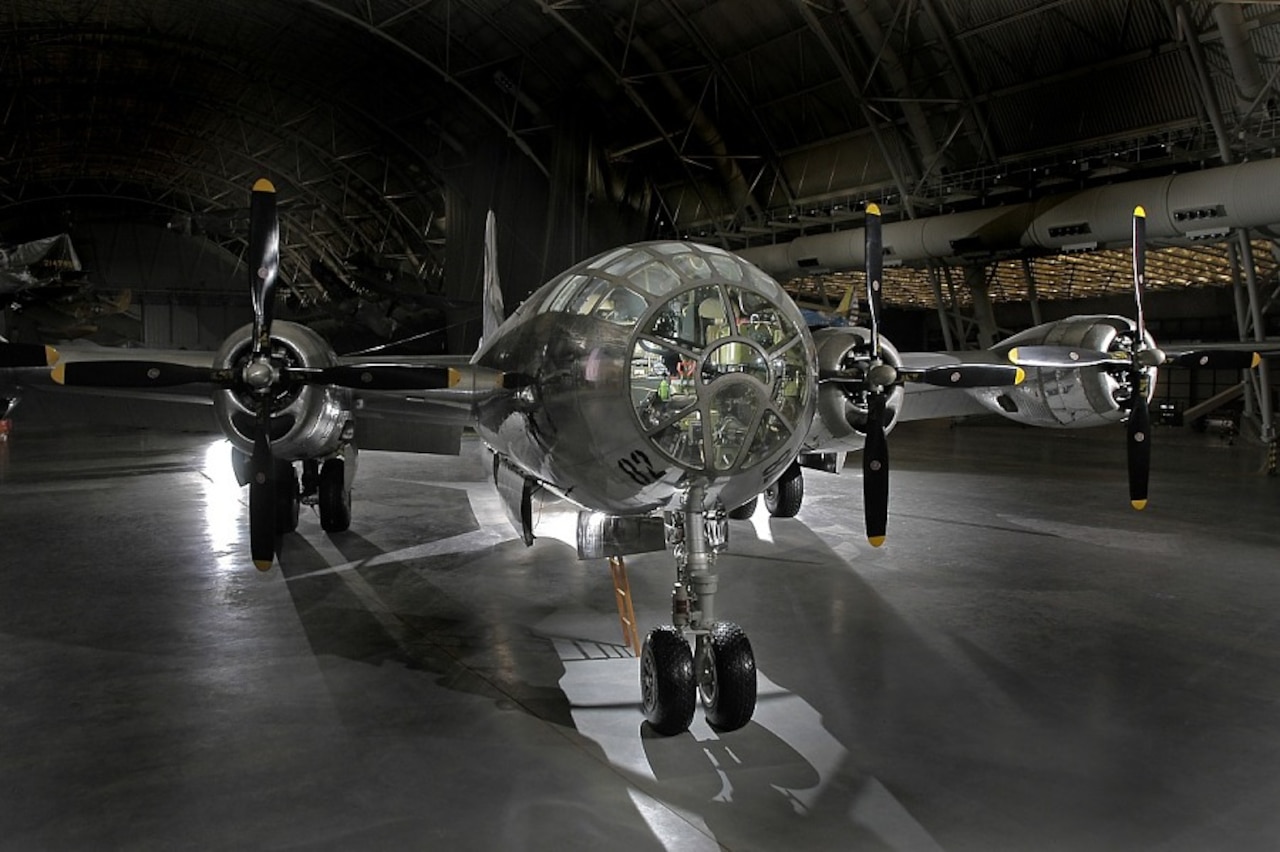 A refurbished B-29 Superfortress sits inside a large hangar.