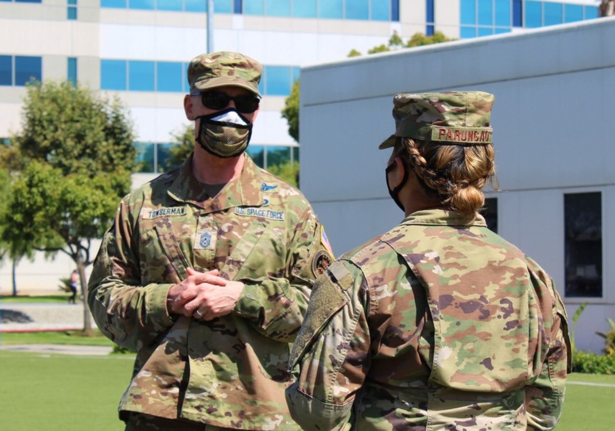 Chief Master Sgt. Roger Towberman, U.S. Space Force Senior Enlisted Advisor, coins Senior Airman Erika Parungao, 61st Medical Squadron Command Support Staff and Medical Command Center technician, before coining her during his first official visit to the Space and Missile Systems Center on July 15, 2020 at Los Angeles Air Force Base, Calif.  Parungao was coined for her outstanding contributions to the overall continuity of operations of LA AFB during the global COVID-19 pandemic. (U.S. Space Force photo by Staff Sgt. Randy Duffy)