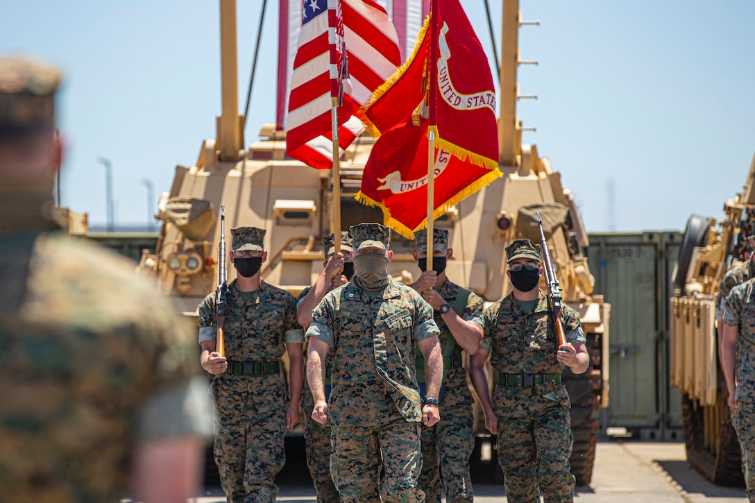 U.S. Marine Capt. Chandler Brown, the executive officer for Alpha Company, 4th Tank Battalion, 4th Marine Division, Marine Forces Reserve, marches forward with the color guard during the company’s deactivation ceremony in 41 Area on Marine Corps Base Camp Pendleton, California, July 18, 2020. Alpha Co., along with the rest of 4th Tank Bn., was activated in 1943 during World War II. Since then, the battalion has participated in every war the Marine Corps has fought in. Alpha Co. is the first of 4th Tanks’ six companies to deactivate. The Marine Corps is divesting its tank battalions following the commandant’s guidance in Force Design 2030. (U.S. Marine Corps photo by Lance Cpl. Andrew Cortez)