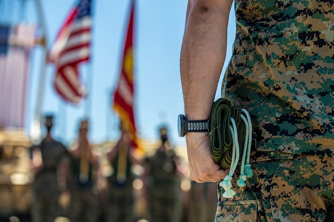U.S. Marine 1st Sgt. Adam Casas, the company first sergeant of Alpha Company, 4th Tank Battalion, 4th Marine Division, Marine Force Reserve, holds two flag cases during the company’s deactivation ceremony in 41 Area on Marine Corps Base Camp Pendleton, California, July 18, 2020. Alpha Co., along with the rest of 4th Tank Bn., was activated in 1943 during World War II. Since then, the battalion has participated in every war the Marine Corps has fought in. Alpha Co. is the first of 4th Tanks’ six companies to deactivate. The Marine Corps is divesting its tank battalions following the commandant’s guidance in Force Design 2030. Casas is a native of Murrieta, California. (U.S. Marine Corps photo by Lance Cpl. Andrew Cortez)