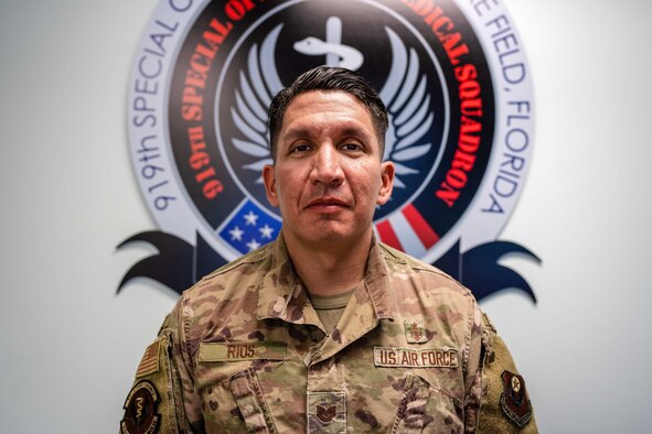 Sergeant standing in front of sign looking at camera