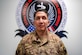 Sergeant standing in front of sign looking at camera