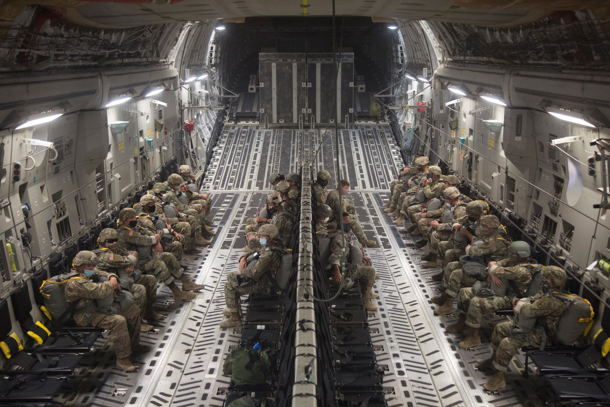 Army Soldiers siting on cargo aircraft