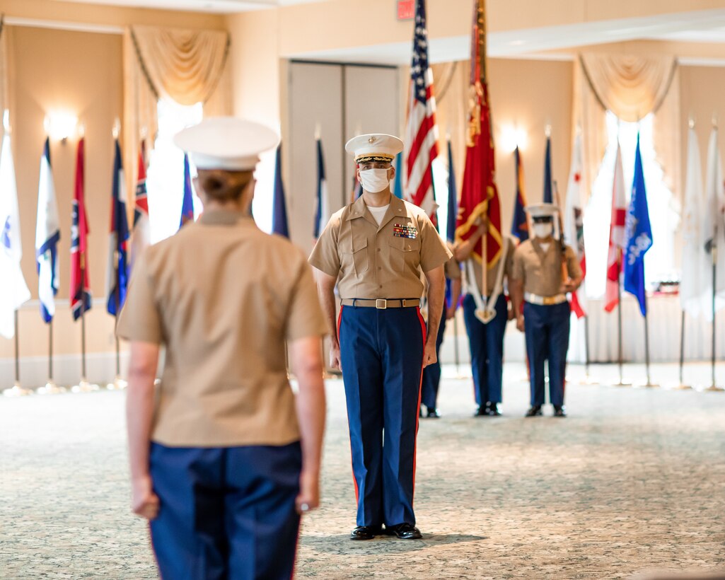 U.S. Marine Corps Lt. Col. Matthew J. Grabowski, center, the commander of troops during the 4th Marine Corps District Change of Command ceremony, receives orders from the new district commanding officer, Col. Heather J. Cotia, left, during the district change of command ceremony at the West Shore Country Club, Camp Hill, Pennsylvania, July 16, 2020. Col. Robert M. Clark relinquished his command to Cotoia after three years commanding the 4th Marine Corps District. (U.S. Marine Corps Photo by Cpl. Cody J. Ohira)