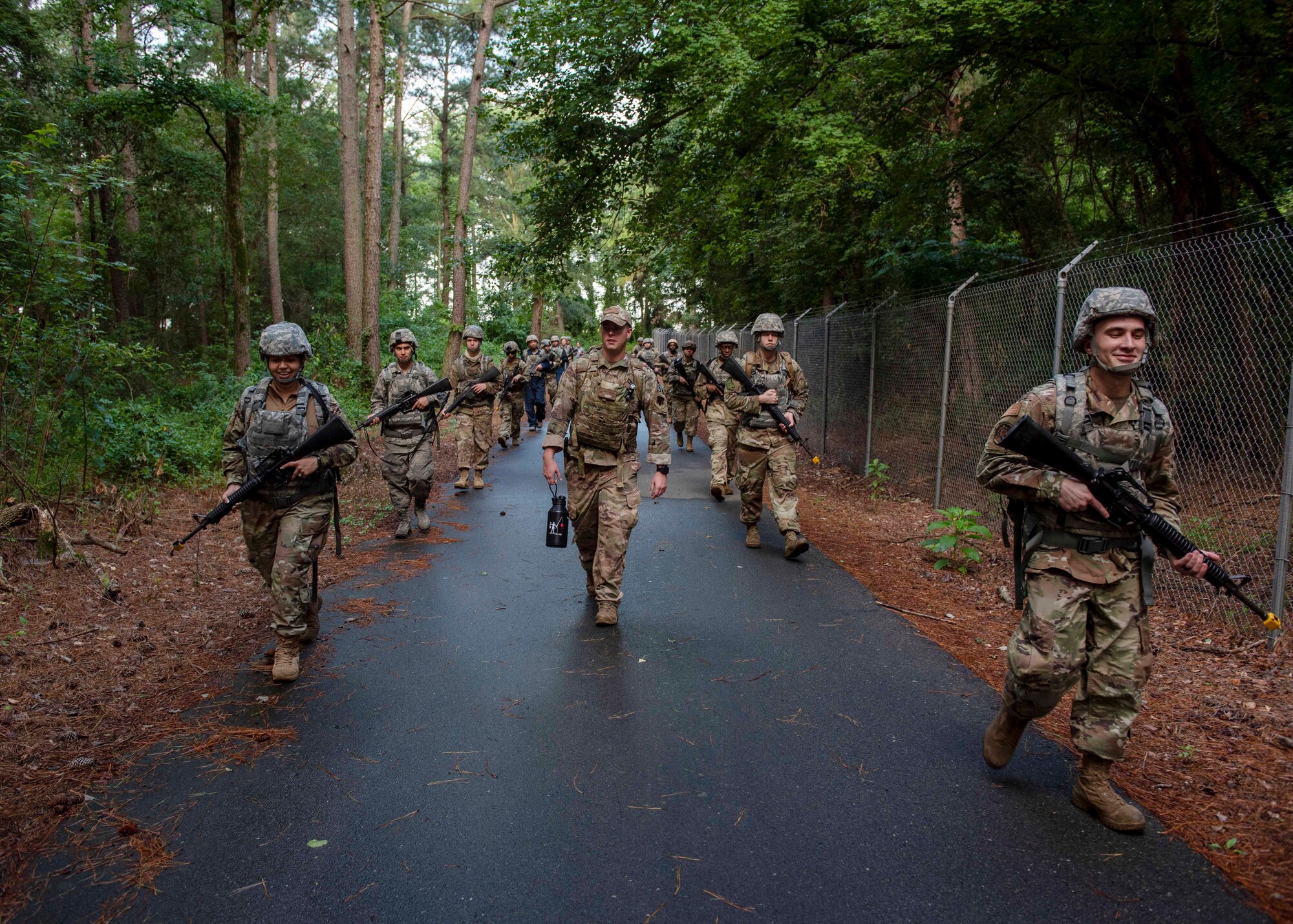 Airman Leadership School graduates ruck along perimeter road during the combat skills training course at Seymour Johnson Air Force Base, North Carolina, July 13, 2020.