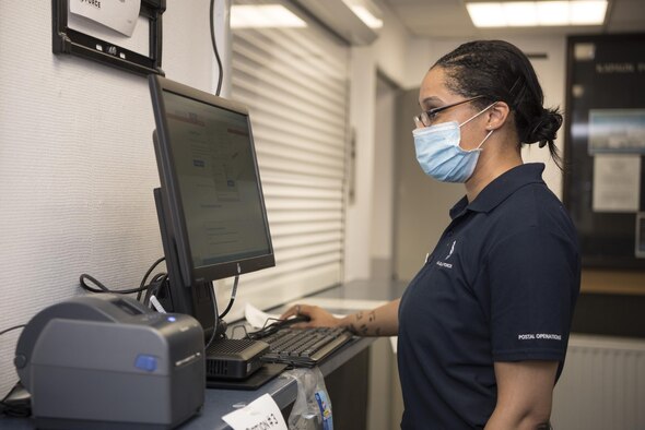 U.S. Air Force Staff Sgt. Jessica Whitehead, 786th Force Support Squadron Kapaun Post Office finance non-commissioned officer in charge, works at one of the two new Click-N-Ship kiosks on Kapaun Air Base, Germany, July 17, 2020. The United States Postal Service will no longer  accept handwritten customs declaration forms starting Aug. 13; customers are encouraged to use the Click-N-Ship feature at home or at one of the kiosks. (U.S. Air Force photo by Senior Airman Kristof J. Rixmann)