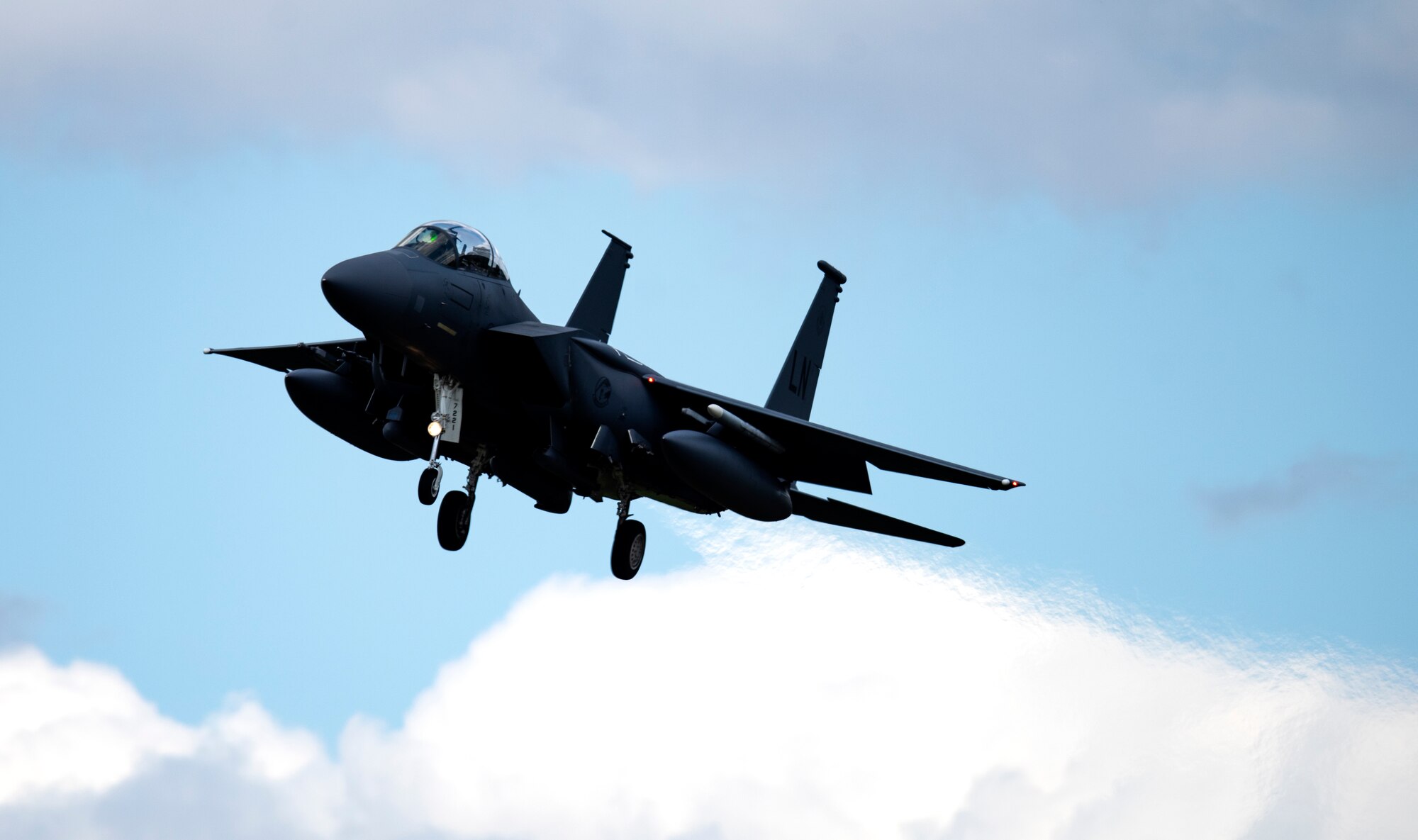 An F-15E Strike Eagle assigned to the 48th Fighter Wing prepares to touch down at Royal Air Force Lakenheath, England, July 20, 2020. The Liberty Wing conducts routine training in order to maintain combat readiness and safeguard U.S. national interests and the collective defense of allies and partners. (U.S. Air Force photo by Airman 1st Class Jessi Monte)