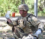 Sgt. 1st Class Jeremy Shepler, Headquarters Medical Professional Training Brigade, prepares to administer intravenous fluids to a simulated casualty on the Best Medic lane.