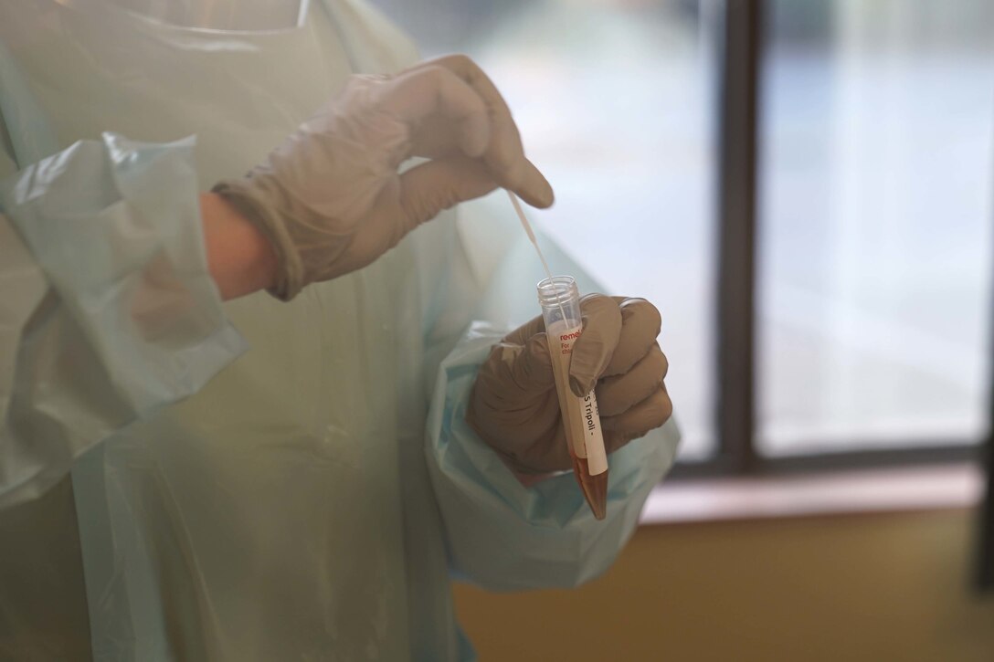 Airmen preparing samples for COVID-19 testing.