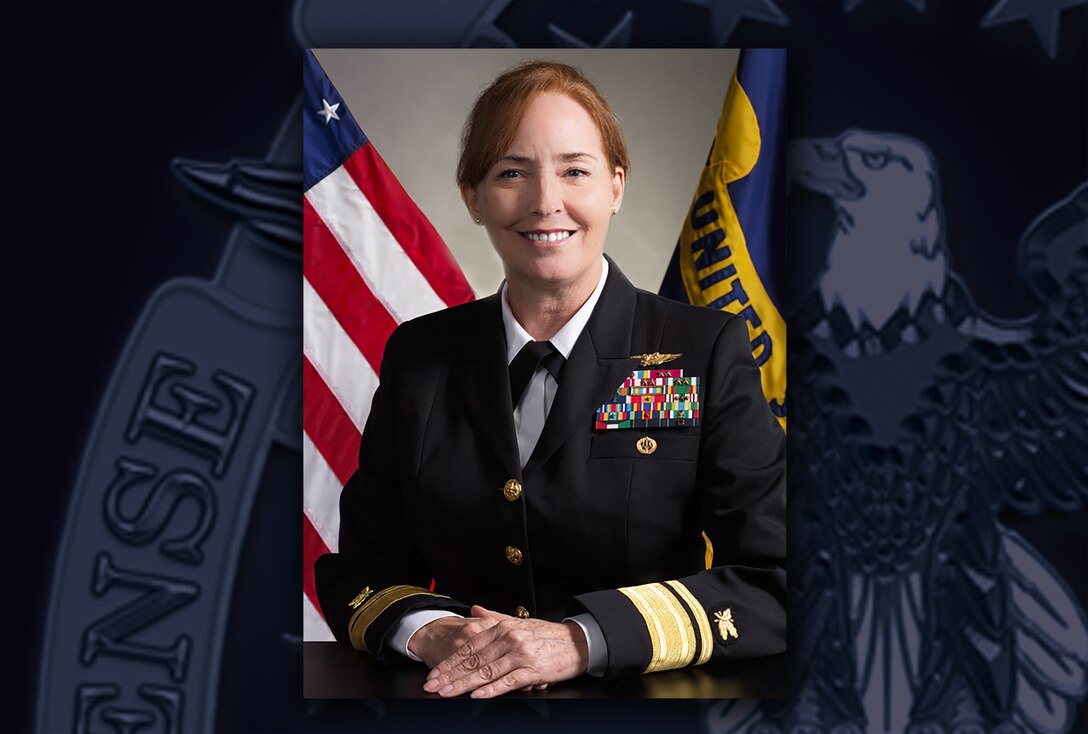 White woman in Navy dress blue uniform with ribbons