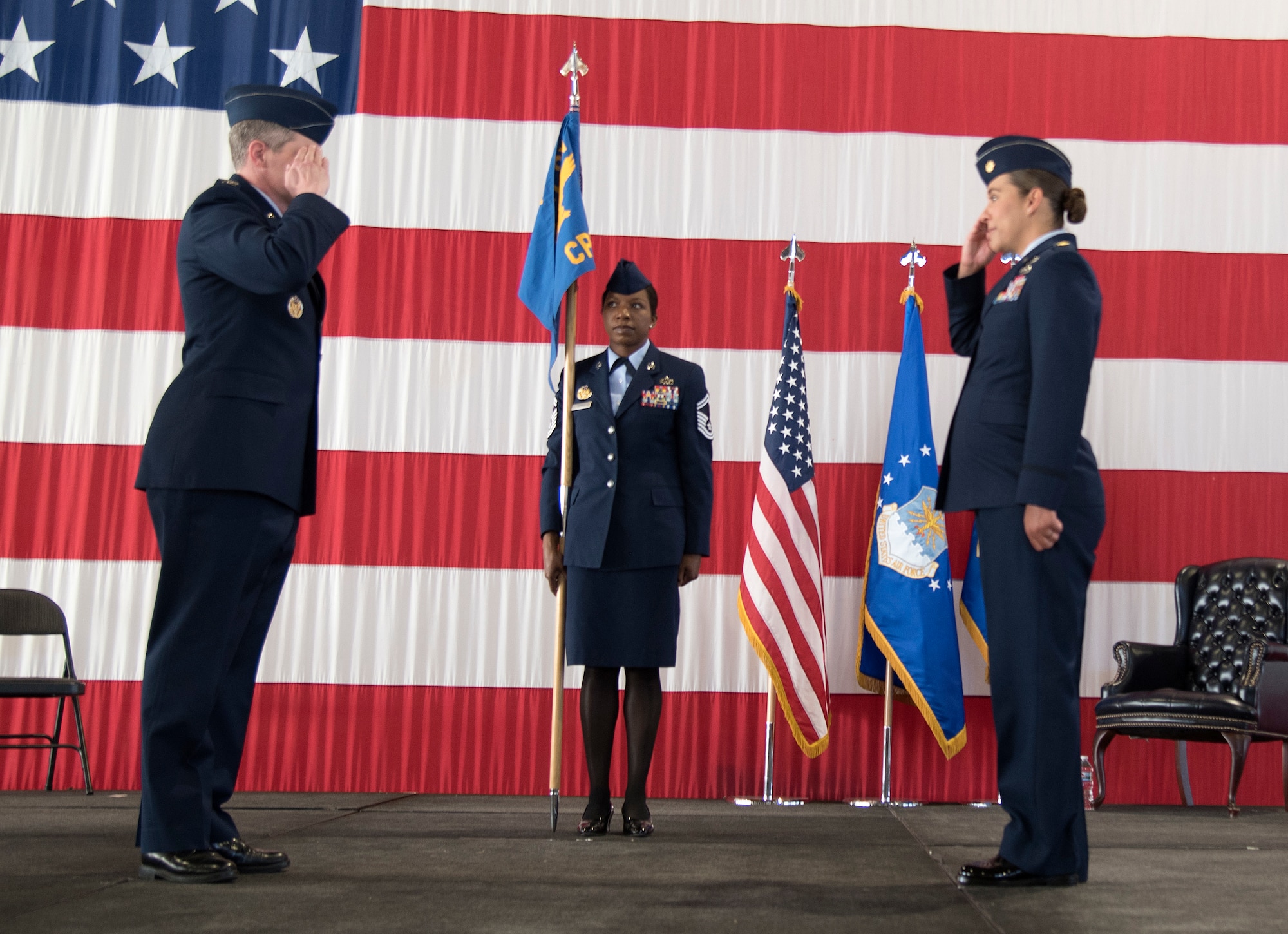 PETERSON AIR FORCE BASE, Colo. - Col. Sam Johnson, 21st Space Wing commander, left, salutes Maj. Ashley Housley as she assumes command of the 21st Comptroller Squadron June 5, 2020 on Peterson Air Force Base, Colorado. The traditional passing of the guidon did not occur in order to maintain proper physical distancing guidelines during the ceremony. (U.S. Air Force photo by Kristen Allen)