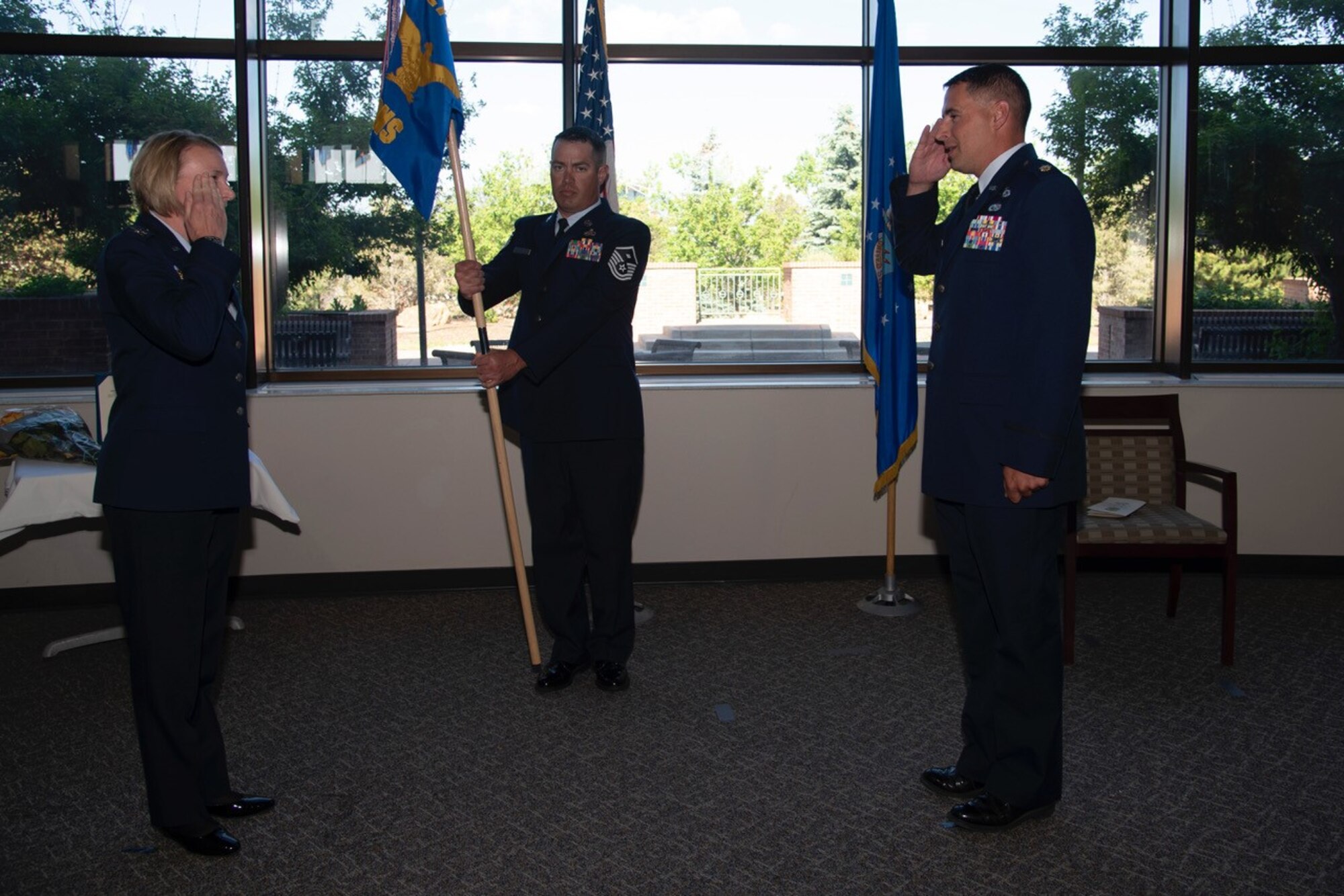 Maj. Cyrus Perry, incoming 21st Contracting Squadron commander, right, accepts command from Col. Kristen Aguilar, 21st Mission Support Group commander,left, during a ceremony June 4, 2020, at Peterson Air Force Base, Colo. The 21 CONS mission is to develop and execute business solutions to support combined global capabilities to defend the homeland and enable space combat operations. (U.S. Air Force photo by Staff Sgt. Alexandra Longfellow)
