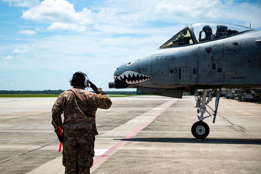 Photo of Airman saluting a departing pilot.