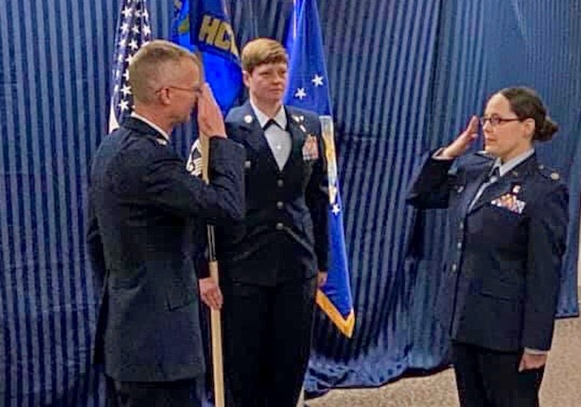 Lt. Col. Holly Dinkel, incoming 21st Healthcare Operations Squadron commander, right, accepts command from Col. Patrick Pohle, 21st Medical Group commander, left, June 12, 2020, at Peterson Air Force Base, Colorado. (Courtesy photo)