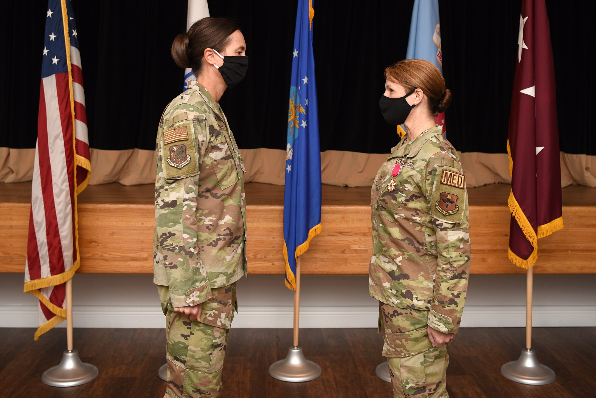 U.S. Air Force Col. Heather Blackwell, 81st Training Wing commander, presents the Legion of Merit to Col. Beatrice Dolihite, outgoing 81st Medical Group commander, inside the Don Wiley Auditorium at Keesler Air Force Base, Mississippi, July 21, 2020. Dolihite relinquished command to Col. Christopher Estridge, incoming 81st MDG commander. (U.S. Air Force photo by Senior Airman Suzie Plotnikov)