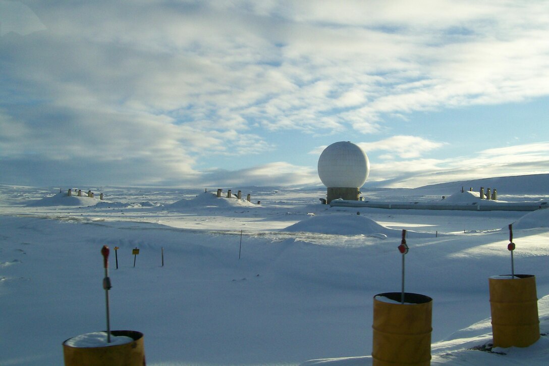A golf-ball-like radar dome sits in a snowy landscape.