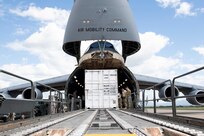 U.S. Airmen assigned to the 22nd Airlift Squadron, Travis Air Force Base, California, off-load a T6 container July 18, 2020, at Soto Cano Air Base, Honduras. The T6 container held 17,000 pounds of COVID-19 medical supplies for Honduras communities. (U.S. Air Force photo by Senior Airman Jonathon Carnell)