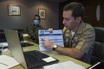 SINGAPORE (July 21, 2020) Lt. Cmdr. Jeff Ryan, exercise planner assigned to Commander, Logistics Group Western Pacific, lays out the schedule of events to virtual participants in support of Southeast Asia Cooperation and Training (SEACAT) 2020. SEACAT promotes shared commitments to maritime partnerships, security and stability in Southeast Asia. This year, SEACAT takes shape as a virtual maritime domain awareness symposium with representatives from 22 participating nations.