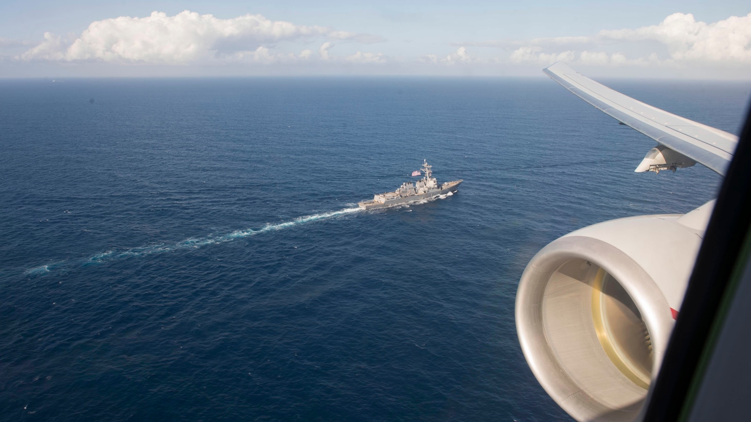 The Arleigh Burke-class guided-missile destroyer USS Roosevelt (DDG 80) as seen from the window of a P-8A Poseidon multi-mission maritime patrol and reconnaissance aircraft assigned to Patrol Squadron (VP), April 23.