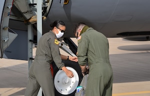 2nd Lt. Keisha Holback and Capt. Ryan Burkitt, 465th air Refueling Squadron pilots, load cleaning supplies onto a KC-135R Stratotanker before a sortie July 21, 2020, at Tinker Air Force Base, Oklahoma. (U.S. Air Force photo by Senior Airman Chad Dixon)