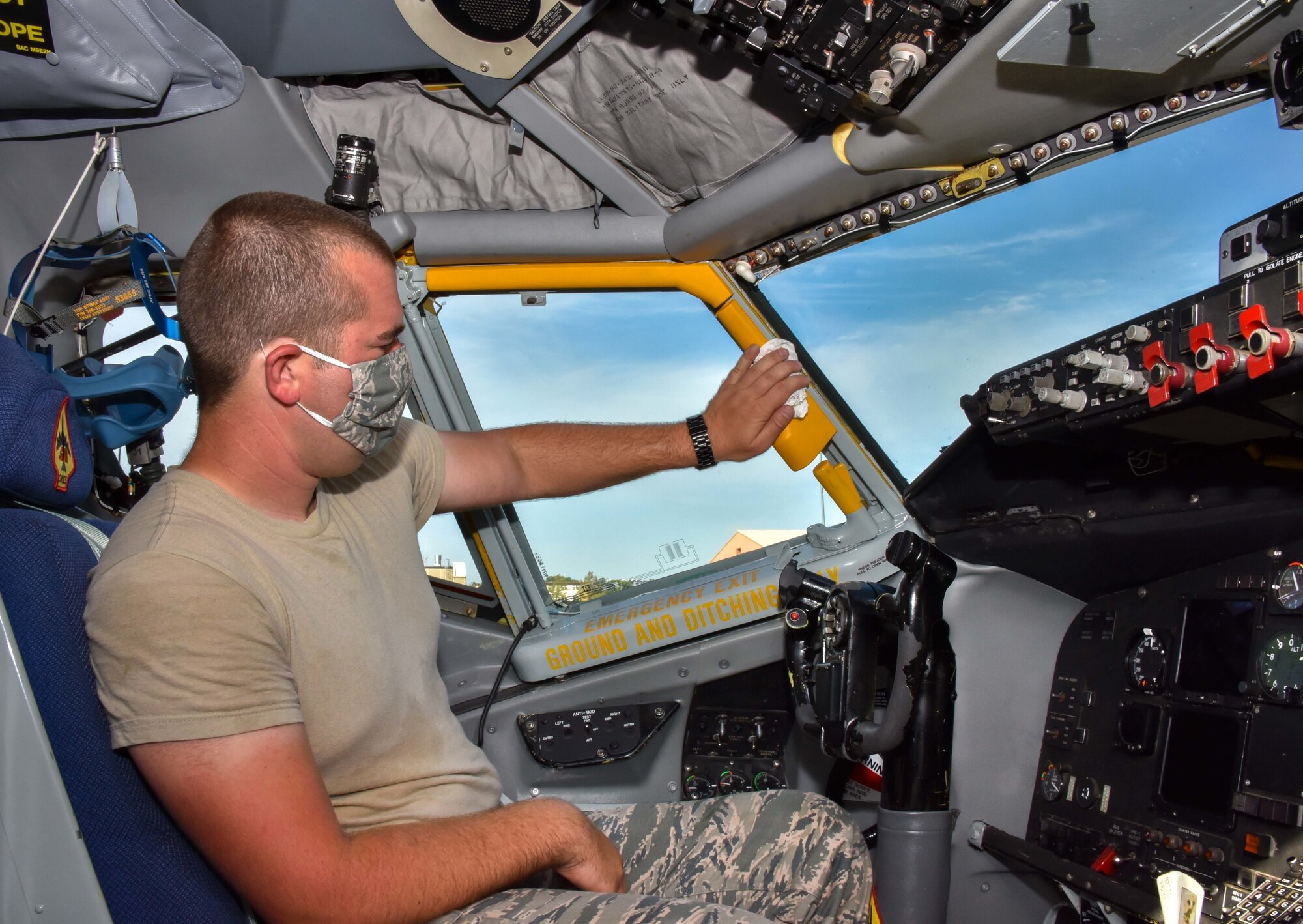 Senior Airman Joshua Thomas, 507th Aircraft Maintenance Squadron crew chief, sanitizes the flight deck of a KC-135R Stratotanker July 20, 2020, at Tinker Air Force Base, Oklahoma. Routine cleaning mitigates the spread of COVID-19 and keeps aircrews safe. (U.S. Air Force photo by Senior Airman Mary Begy)