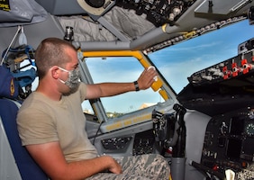 Senior Airman Joshua Thomas, 507th Aircraft Maintenance Squadron crew chief, sanitizes the flight deck of a KC-135R Stratotanker July 20, 2020, at Tinker Air Force Base, Oklahoma. Routine cleaning mitigates the spread of COVID-19 and keeps aircrews safe. (U.S. Air Force photo by Senior Airman Mary Begy)