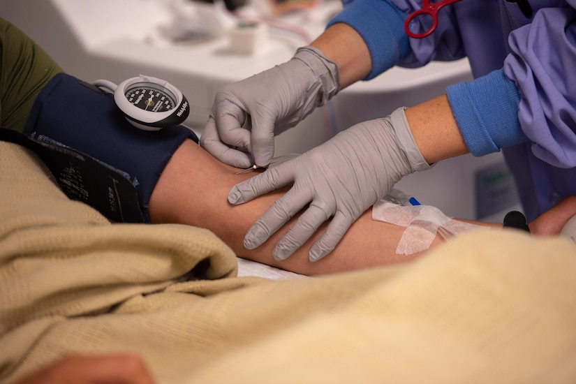 A phlebotomist drawing and testing blood.