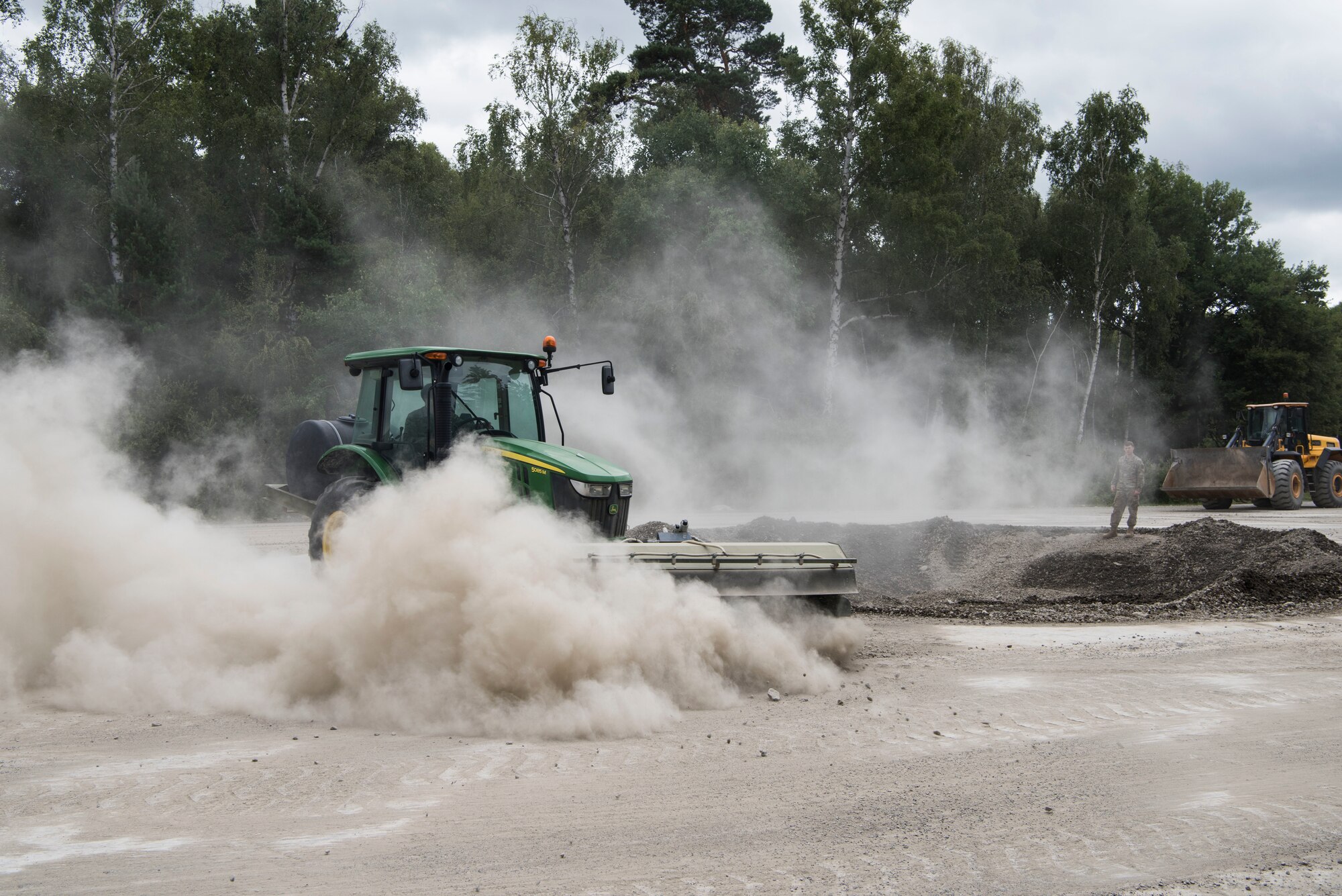 U.S. Air Force Airmen assigned to the 786th Civil Engineer Squadron move and clear out dirt during legacy crater repair training during Silver Flag