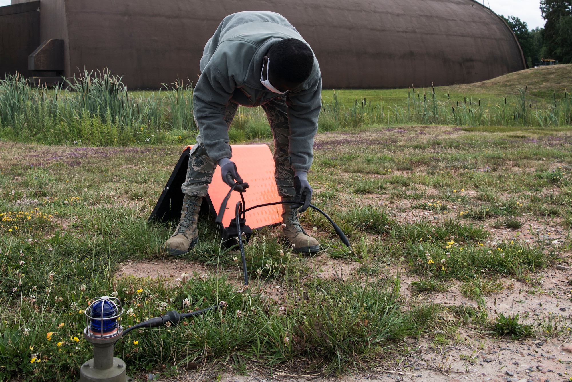U.S. Air Force Airman 1st Class Kofi Oppong, 786th Civil Engineer Squadron electrical system apprentice, connects an expeditionary airfield lighting system during Silver Flag.