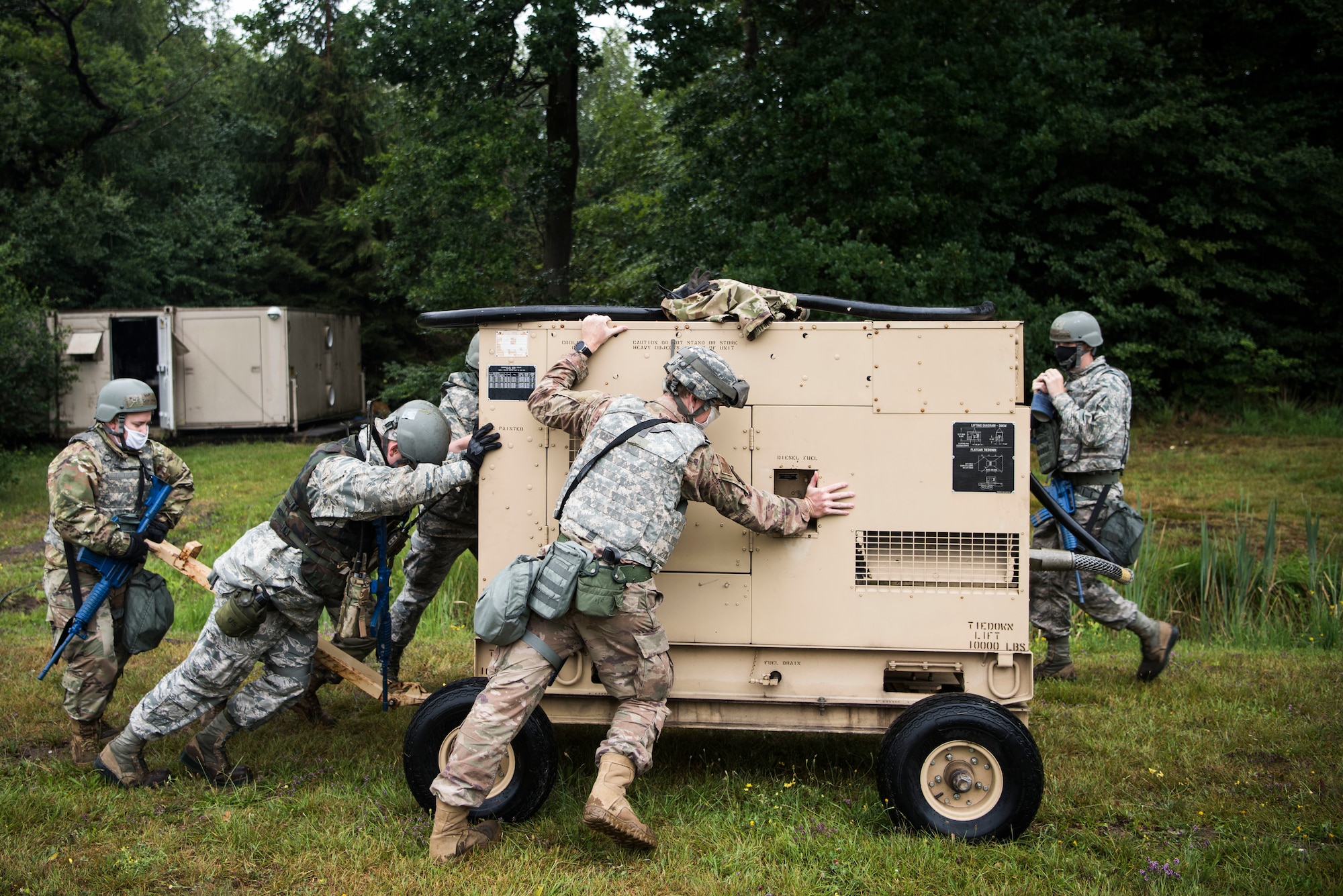 U.S. Air Force Airmen push a generator during Silver Flag.