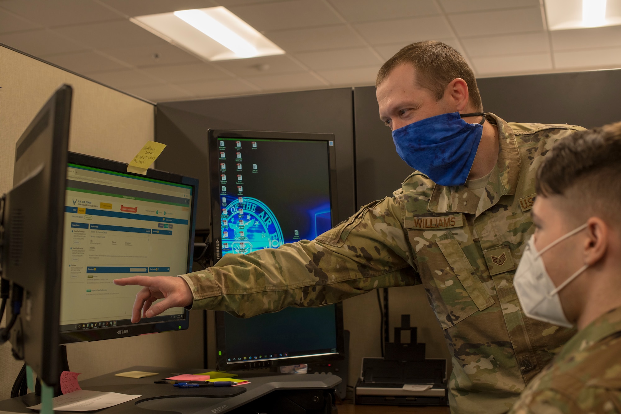 Staff Sgt. Wade Williams, left, 49th Comptroller Squadron special actions noncommissioned officer in charge, shows Staff Sgt. John Demko, 49th CPTS financial operations supervisor, how to navigate the new Comptroller Services Portal system, July 15, 2020, at the 49th CPTS on Holloman Air Force Base, N.M. Holloman members with ‘us.af.mil’ e-mail addresses can look forward to having items such as basic allowance for housing, hardship duty pay and clothing allowance taken care of through this new online program that begins July 27.  (U.S. Air Force photo by Senior Airman Collette Brooks)