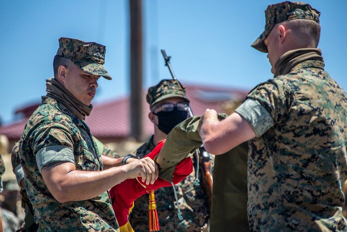 U.S. Marine 1st Sgt. Adam Casas, left, the company first sergeant of Alpha Company, 4th Tank Battalion, 4th Marine Division, Marine Force Reserve, and Capt. Mark Rothrock, the company commander of Alpha Co., 4th Tank Bn., 4th MarDiv, MARFORRES, case the company's colors during the company’s deactivation ceremony in 41 Area on Marine Corps Base Camp Pendleton, California, July 18, 2020. Alpha Co., along with the rest of 4th Tank Bn., was activated in 1943 during World War II. Since then, the battalion has participated in every war the Marine Corps has fought in. Alpha Co. is the first of 4th Tanks’ six companies to deactivate. The Marine Corps is divesting its tank battalions following the commandant’s guidance in Force Design 2030. Casas is a native of Murrieta, California, and Rothrock is a native of Raleigh, North Carolina. (U.S. Marine Corps photo by Lance Cpl. Alison Dostie)