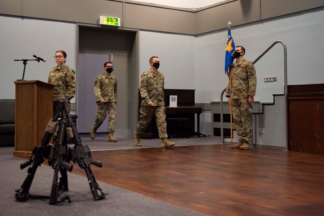 U.S. Air Force Col. Jon Hannah, center right, 422nd Air Base Group commander, and Maj. Thomas Uhl, center left, 422nd Security Forces Squadron (SFS) incoming commander, enter during the 422nd SFS Assumption of Command ceremony at RAF Croughton, England, July 22, 2020. The change of command ceremony is rooted in military history dating back to the 18th century representing the relinquishing of power from one officer to another. (U.S. Air Force photo by Airman 1st Class Jennifer Zima)