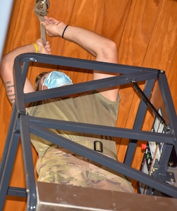 Senior Airman Logan Smith, a water and fuel system maintenance journeyman assigned to the 628th Civil Engineer Squadron, checks for a leak on a sprinkler head for a restored fire suppression system inside the dining facility at Joint Base Charleston, S.C., July 15, 2020. Members of the 628th CES/ WFSM work to support and maintain the water systems needed to keep the mission going and maintain readiness.