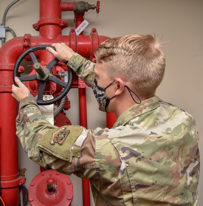 Senior Airman Hunter Olson, a water and fuel system maintenance journeyman assigned to the 628th Civil Engineer Squadron, restores water to the fire suppression system inside the dining facility at Joint Base Charleston, S.C., July 15, 2020. Members of the 628th CES/ WFSM work to support and maintain the water systems needed to keep the mission going and maintain readiness.