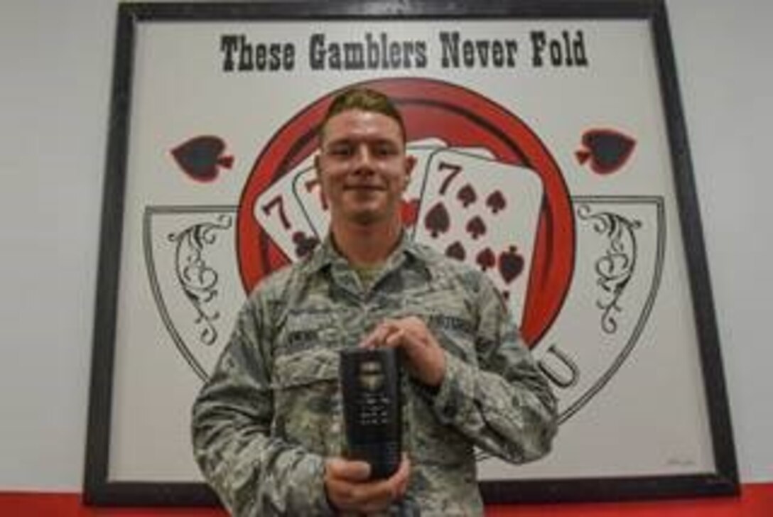 U.S. Air Force Airman 1st Class Jacob Lamons, 77th Fighter Squadron assistant dedicated crew chief, holds his weasel mug at Shaw Air Force Base (AFB) South Carolina, July 20, 2020.