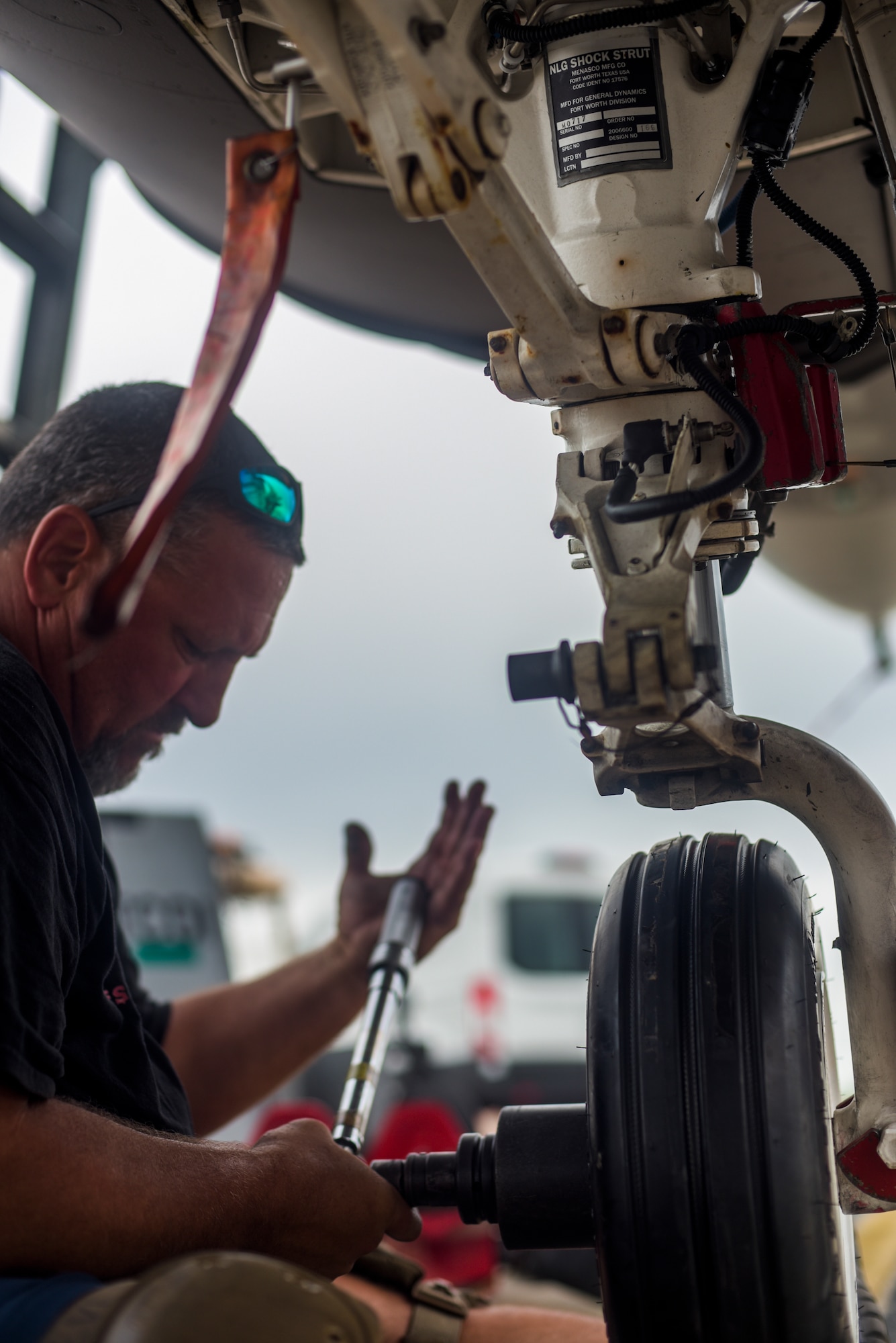 Michael Reeves with the 82nd Aerial Targets Squadron, contractor, tightens the nuts and bolts after replacing the tire of the front landing gear of a QF-16 at Tyndall Air Force Base, Florida, July 9, 2020. The 82nd ARTS contractors fulfill a variety of different flight line technical skills including replacing old or malfunctioning landing gear. (U.S. Air Force photo by Staff Sgt. Magen M. Reeves)