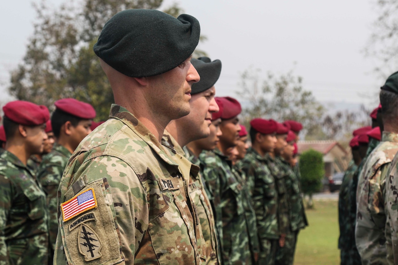 U.S., Thai soldiers stand in formation.