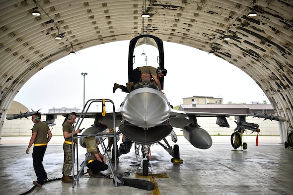 A photo of Airmen performing maintenance on aircraft.