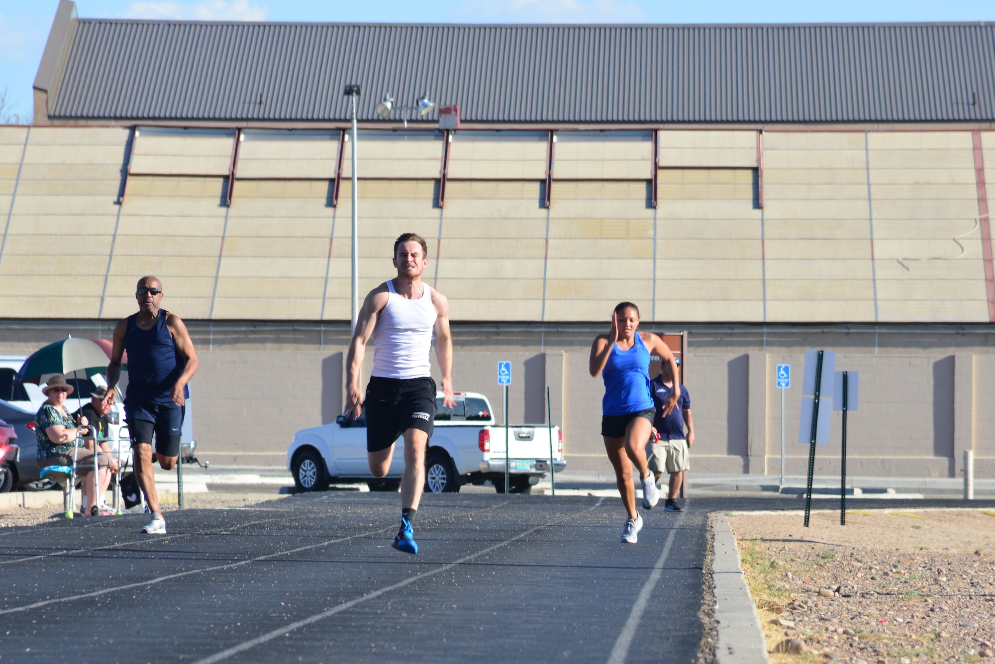 Airmen run on a track.